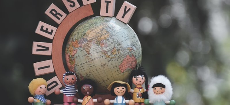 muñecos de todo el mundo con una bola del mundo detrás y las letras university