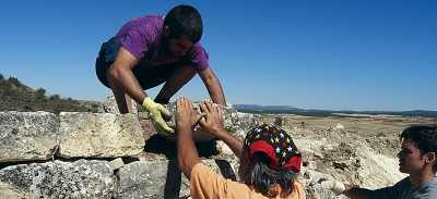 El profesor Marcos Iturriaga repara parte del muro del castro celtibérico con la colaboración del profesor Francesc Tuset